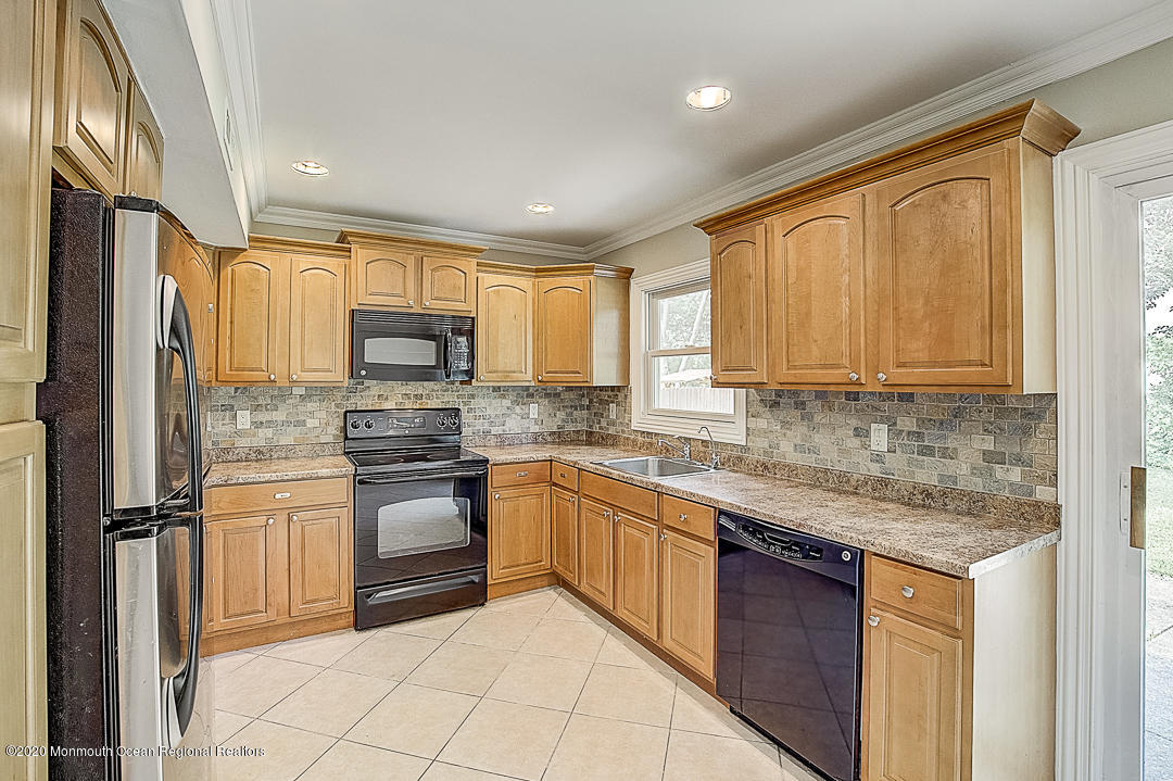 257 Lloyd Road Aberdeen, NJ 07747 - Photo 6 of 46 a kitchen with stainless steel appliances granite countertop a refrigerator sink and stove