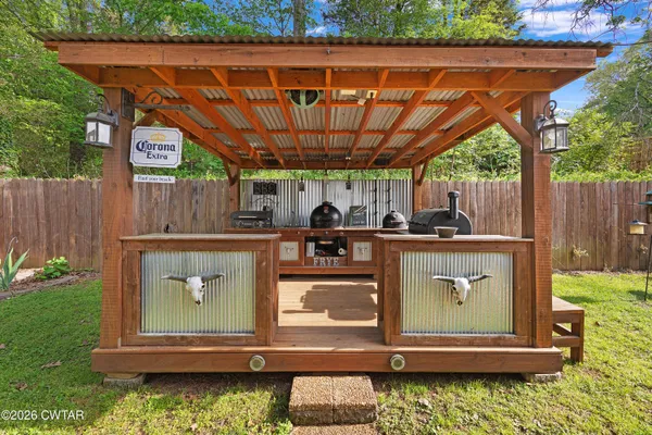 a view of a backyard with wooden fence
