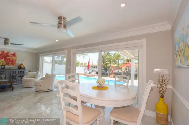 a view of a dining room with furniture a chandelier and wooden floor