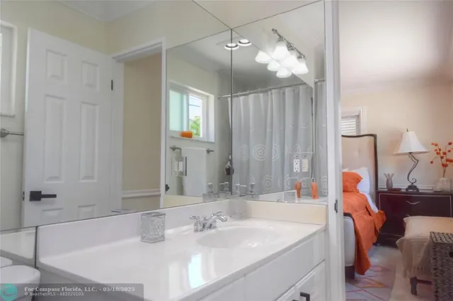 a bathroom with a tub sink and mirror