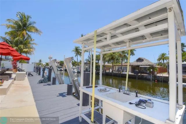 a view of a swimming pool with a patio and a lake view