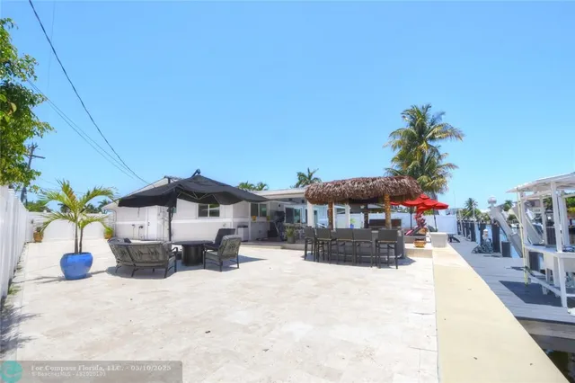a view of a house with a yard and sitting area
