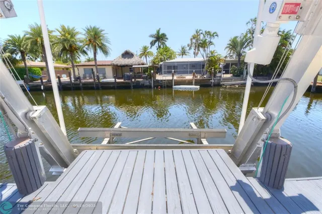 a view of a house with pool table and chairs
