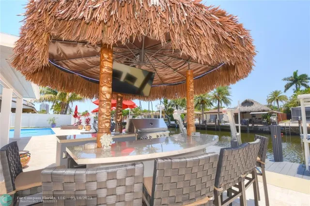 a view of a swimming pool with outdoor seating