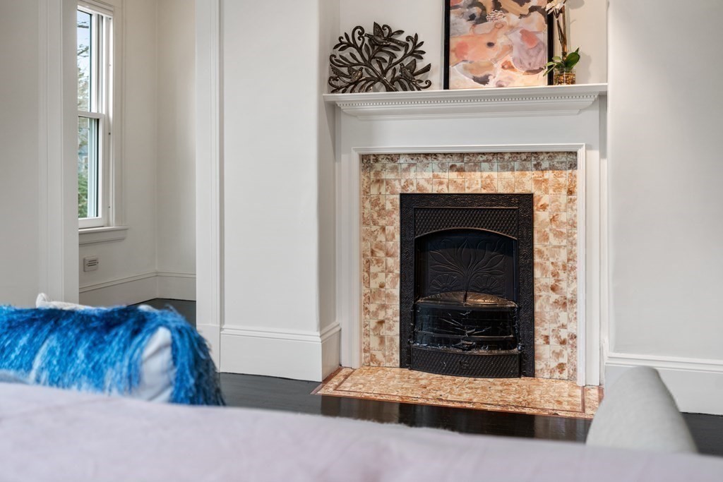 85 Prince Street Newton, MA 02465 - Photo 15 of 37 a living room with a fireplace and a rug