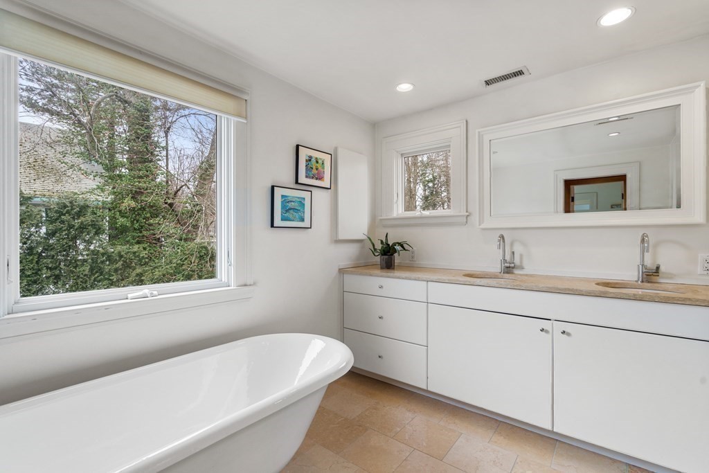 85 Prince Street Newton, MA 02465 - Photo 18 of 37 a bathroom with a granite countertop sink mirror toilet and bathtub