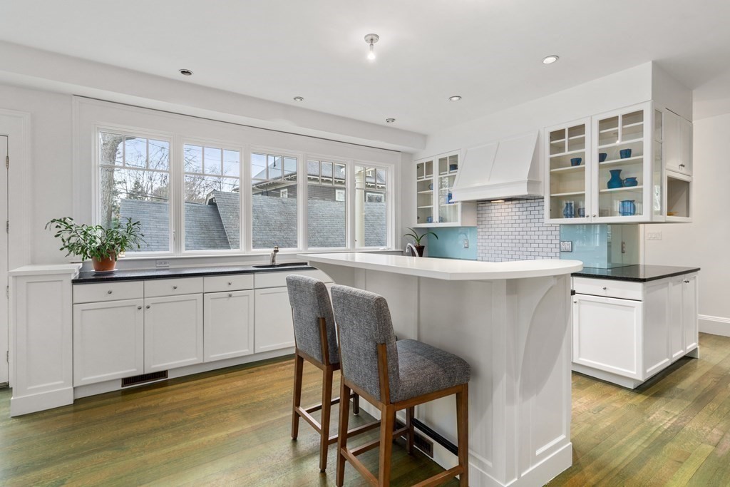 85 Prince Street Newton, MA 02465 - Photo 8 of 37 a kitchen with stainless steel appliances granite countertop a white cabinets and a stove top oven
