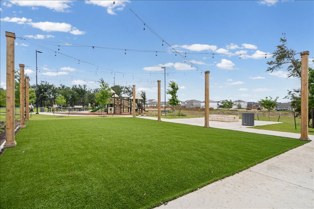 158 Gullivers Drive Elgin, TX 78621 - Photo 32 of 36 Look at this gorgeous green event lawn! It is perfectly manicured with artificial turf, so it’s always lush and pristine.