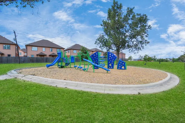 a view of outdoor space with playground and green space