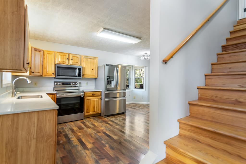 65 Ivy Ridge Ellijay, GA 30536 - Photo 19 of 28 a kitchen with granite countertop a sink cabinets and stainless steel appliances