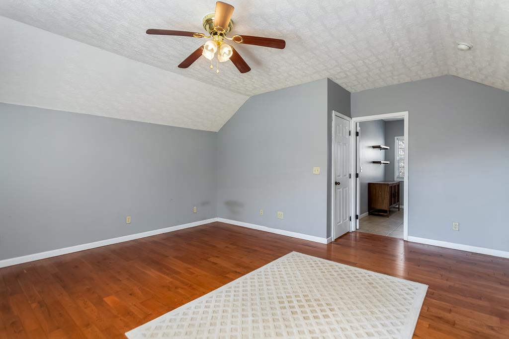 65 Ivy Ridge Ellijay, GA 30536 - Photo 22 of 28 wooden floor in an empty room with a chandelier fan