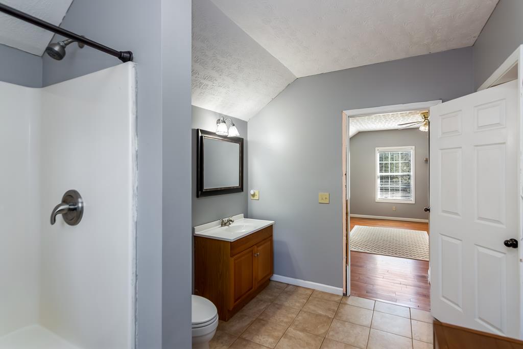 65 Ivy Ridge Ellijay, GA 30536 - Photo 25 of 28 a bathroom with a tub sink and mirror