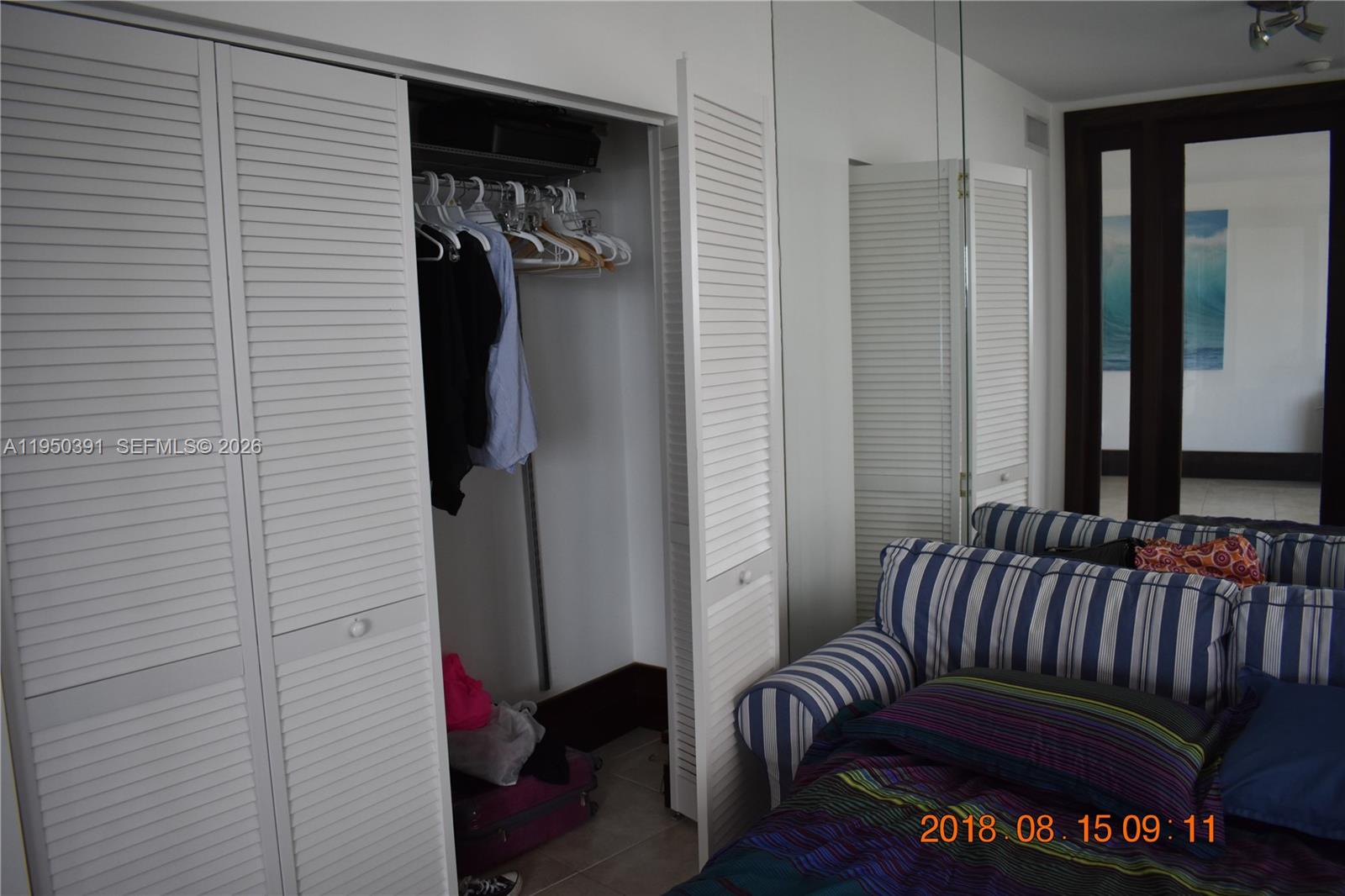 5255 Collins Avenue, Unit 4F Miami Beach, FL 33140 - Photo 12 of 20 a view of a bedroom with a bed and a window