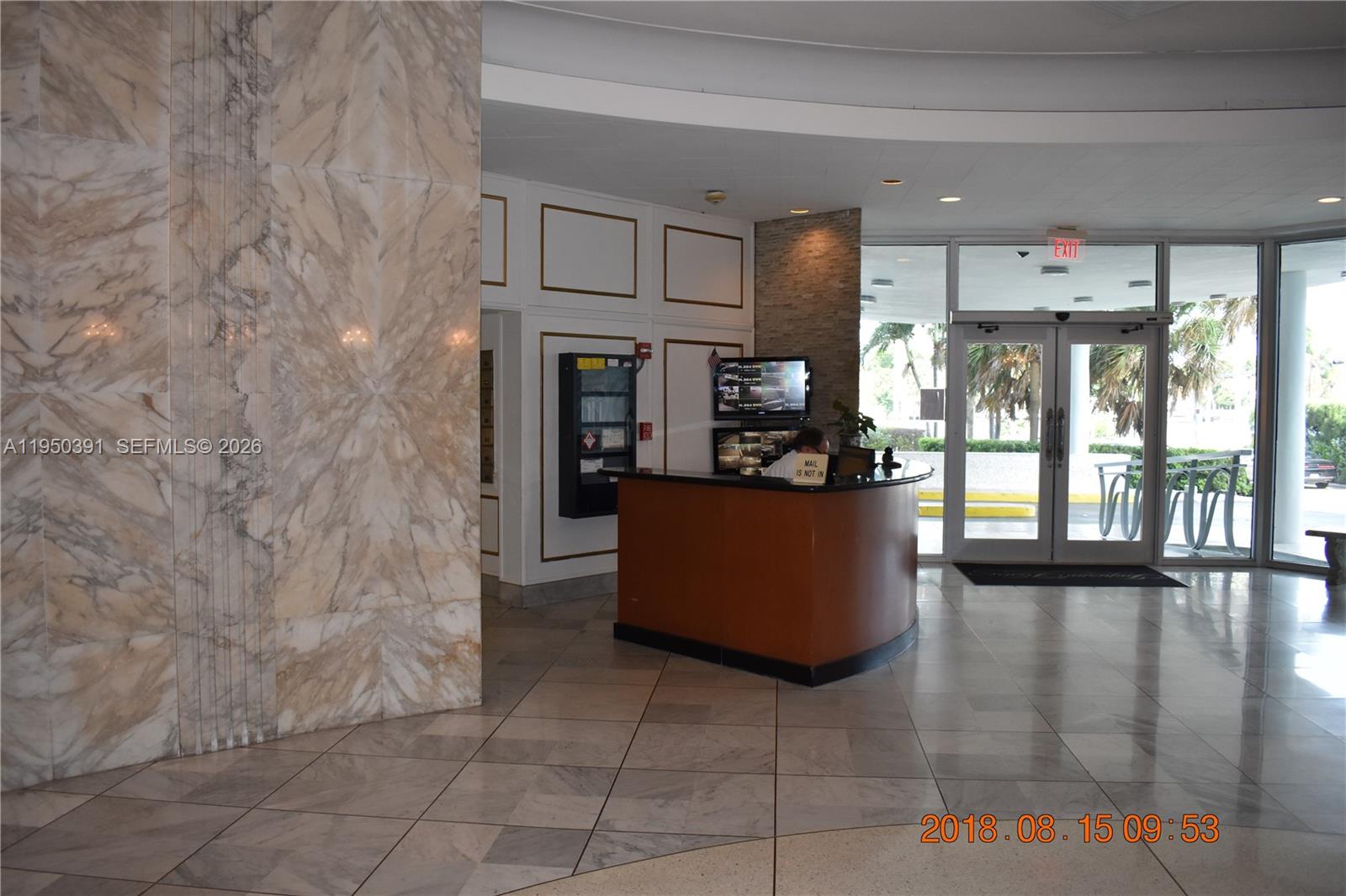 5255 Collins Avenue, Unit 4F Miami Beach, FL 33140 - Photo 19 of 20 a kitchen with stainless steel appliances kitchen island granite countertop a refrigerator and a stove