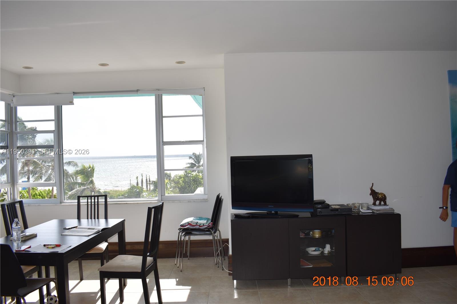 5255 Collins Avenue, Unit 4F Miami Beach, FL 33140 - Photo 8 of 20 a living room with furniture and a flat screen tv