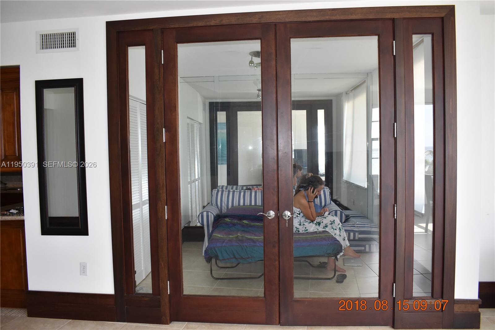 5255 Collins Avenue, Unit 4F Miami Beach, FL 33140 - Photo 9 of 20 view of living room and front door