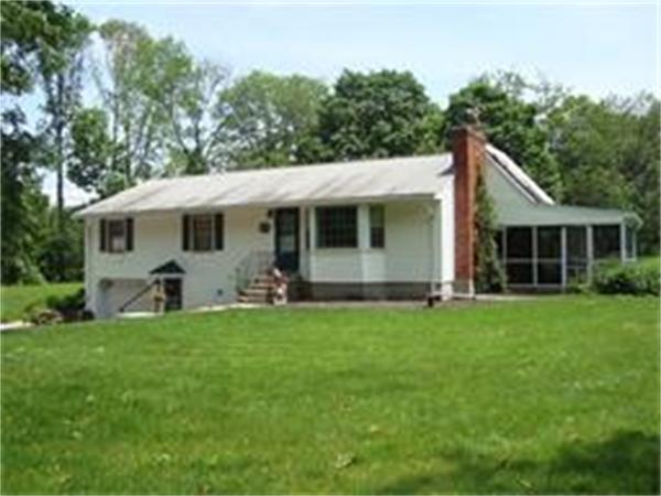 53 Putnam Hill Road Sutton, MA 01590 - Photo 1 of 15 a front view of house with yard and green space
