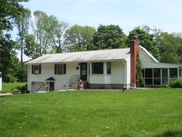 53 Putnam Hill Road Sutton, MA 01590 - Photo 2 of 15 a front view of house with a garden and trees