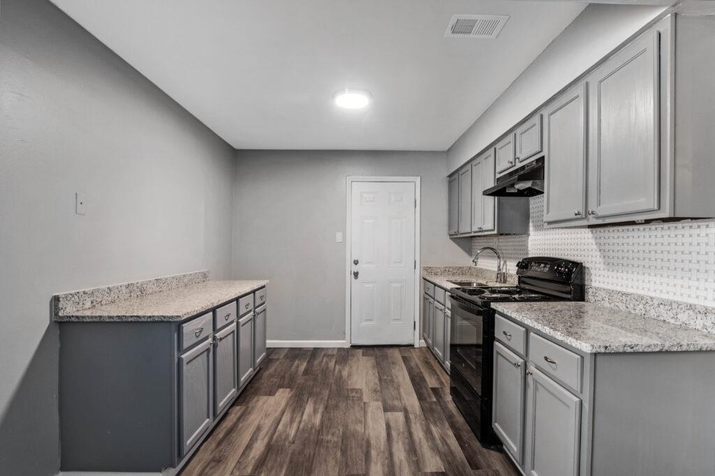 802 Pendleton Street Memphis, TN 38114 - Photo 16 of 22 a kitchen with stainless steel appliances granite countertop a stove a sink and a refrigerator