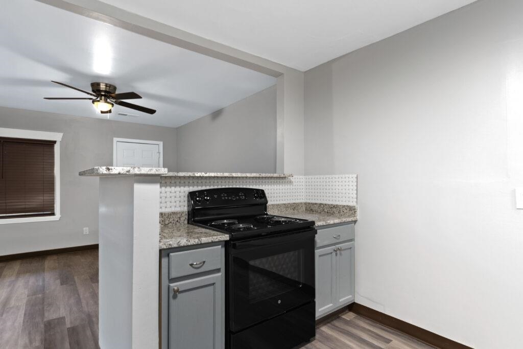 802 Pendleton Street Memphis, TN 38114 - Photo 19 of 22 a kitchen with stainless steel appliances granite countertop a stove and a refrigerator