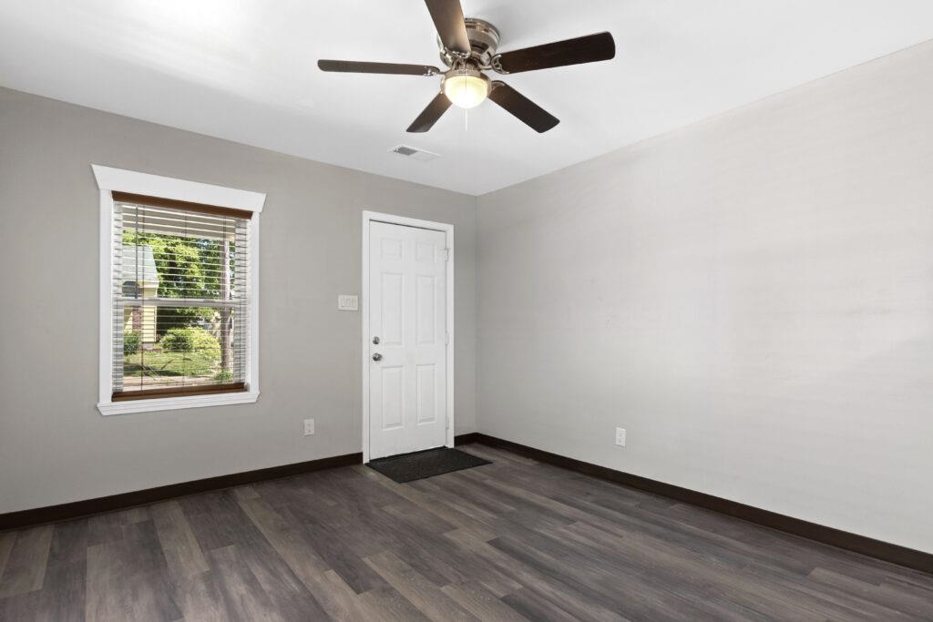 802 Pendleton Street Memphis, TN 38114 - Photo 21 of 22 an empty room with wooden floor ceiling fan and windows