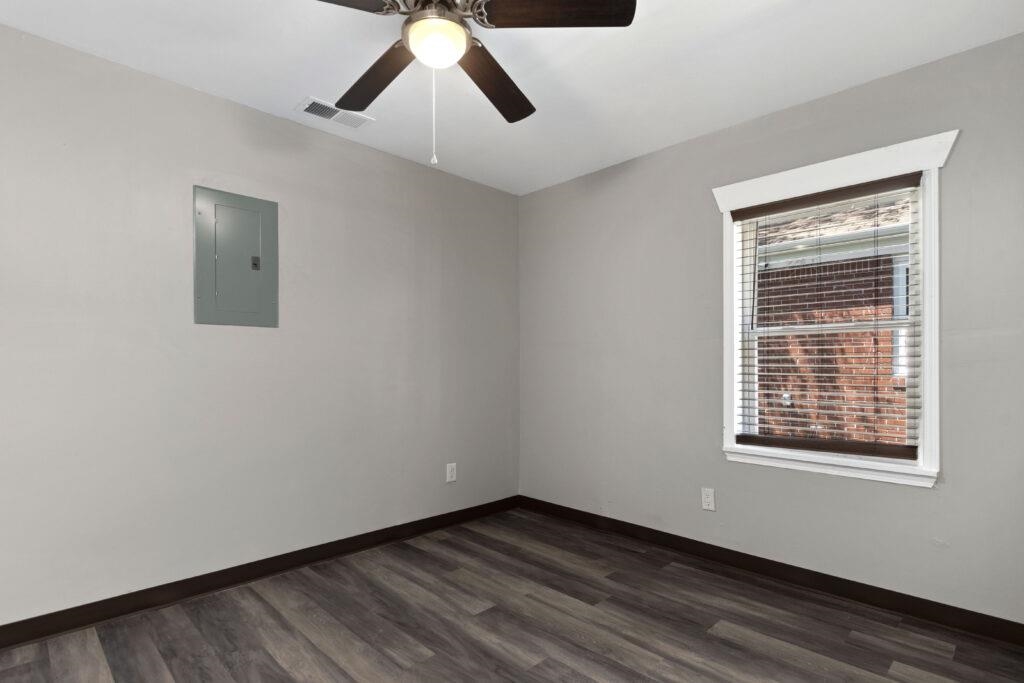 802 Pendleton Street Memphis, TN 38114 - Photo 22 of 22 a view of an empty room with wooden floor and a window