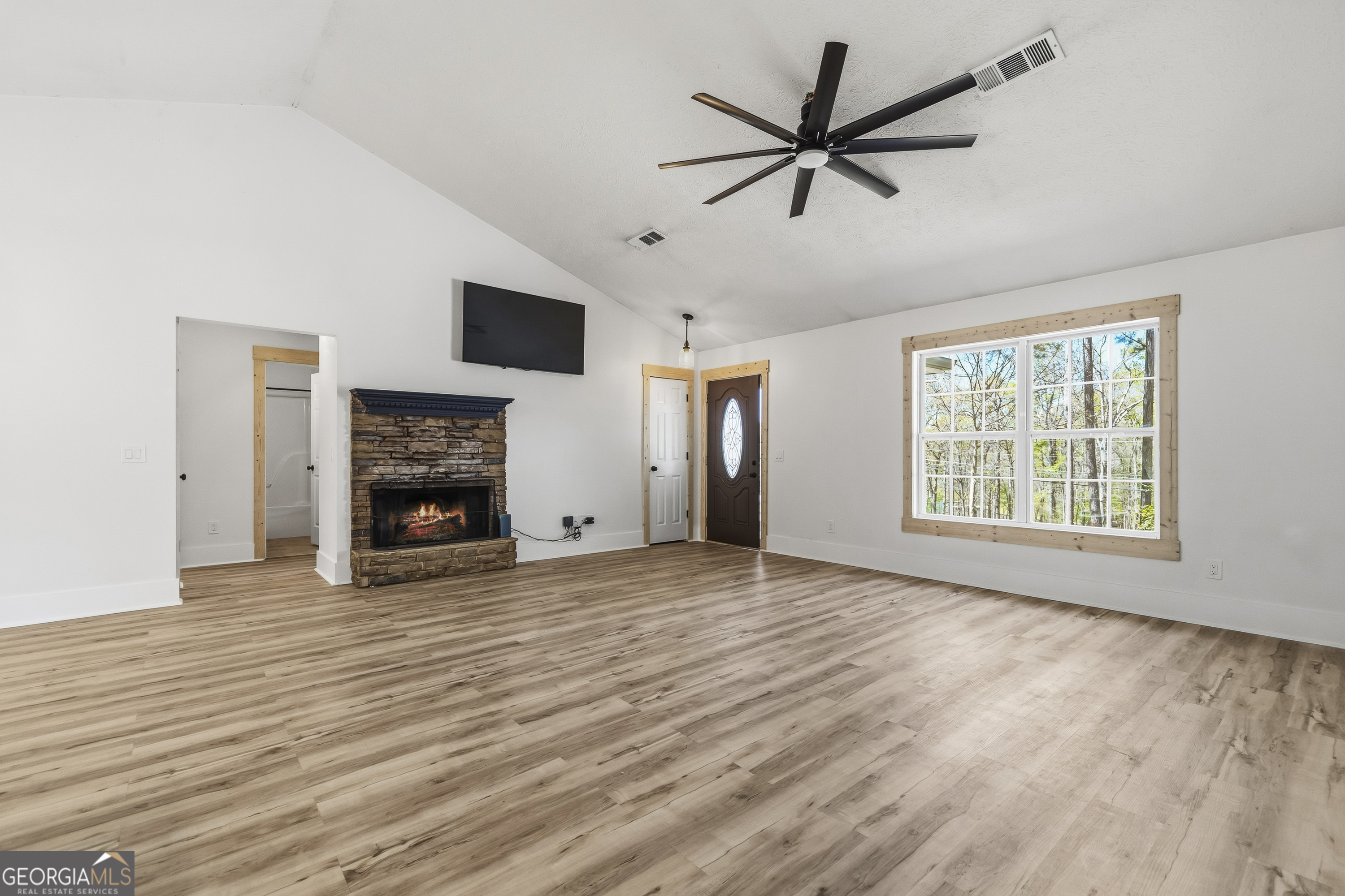 176 Arrowhead Trail Eatonton, GA 31024 - Photo 11 of 45 a view of empty room with fireplace and wooden floor