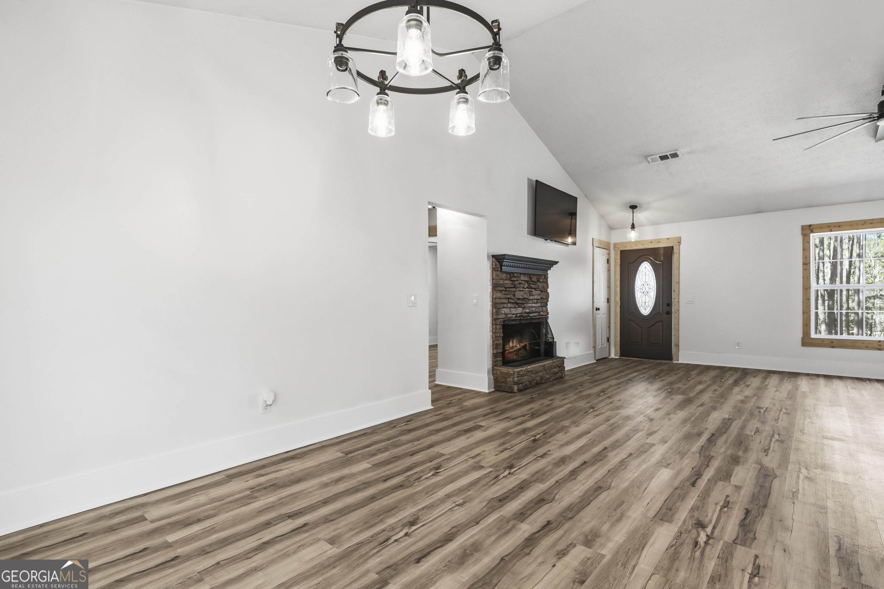 176 Arrowhead Trail Eatonton, GA 31024 - Photo 12 of 45 a view of empty room with wooden floor and window