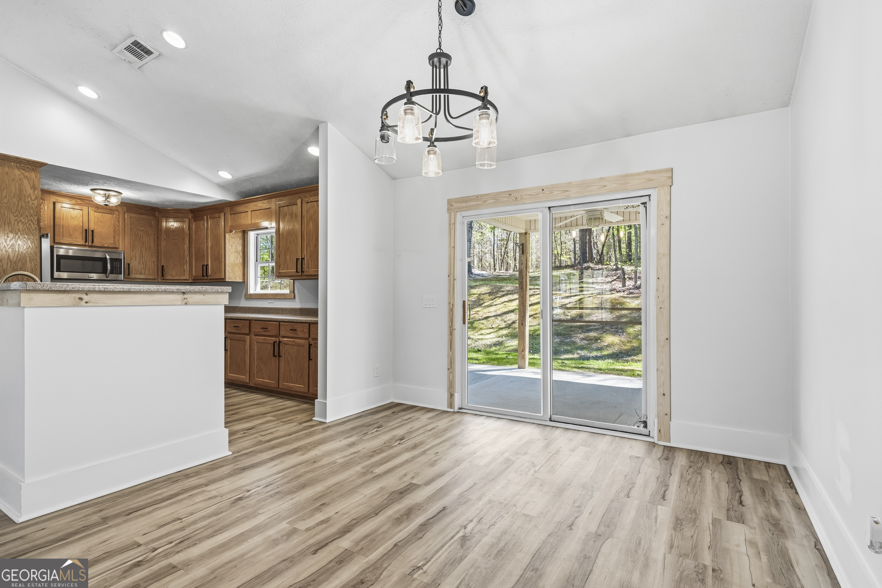 176 Arrowhead Trail Eatonton, GA 31024 - Photo 13 of 45 a view of a kitchen with a stove wooden floor and a window