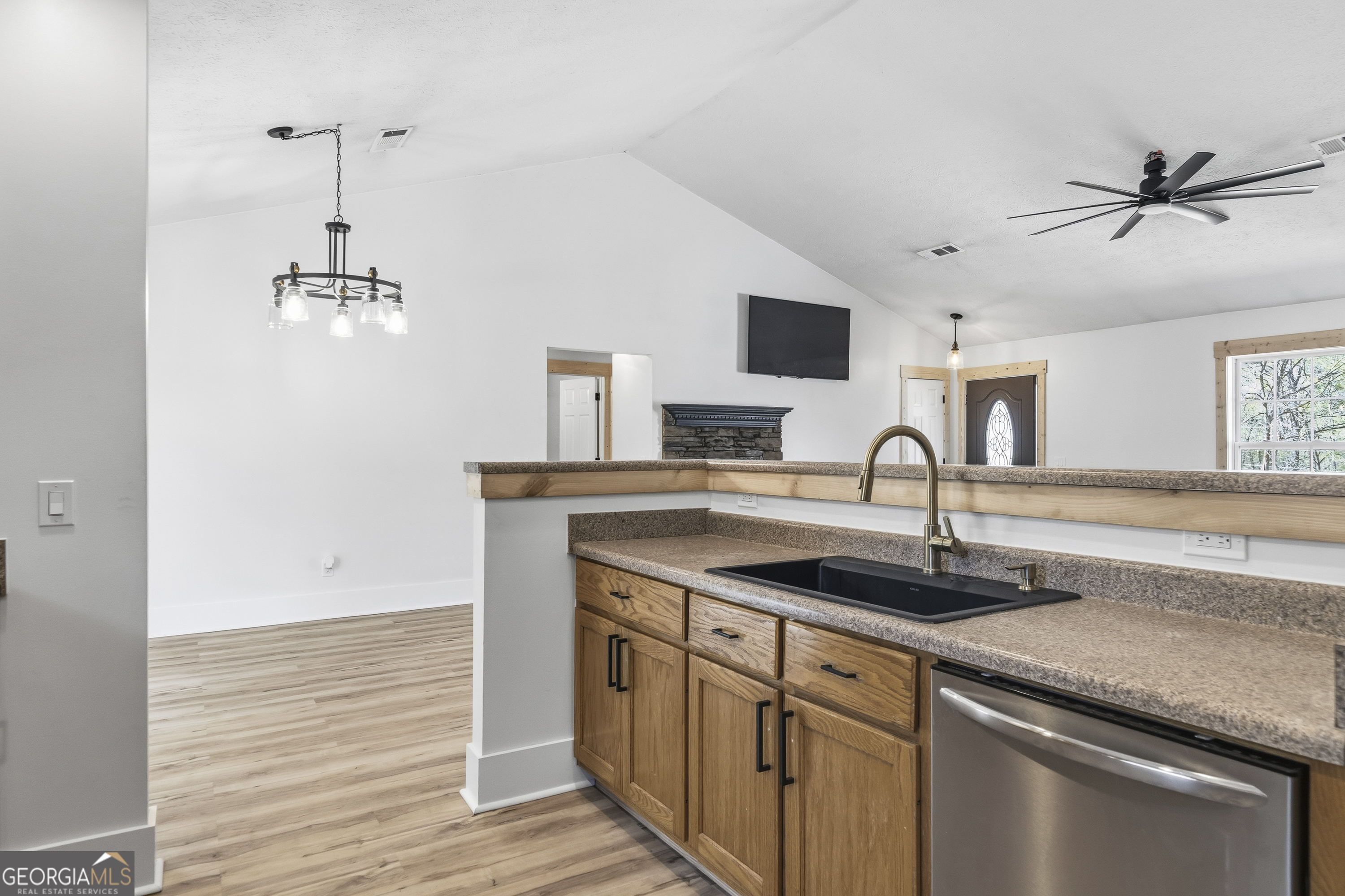 176 Arrowhead Trail Eatonton, GA 31024 - Photo 19 of 45 a kitchen with a sink and a refrigerator
