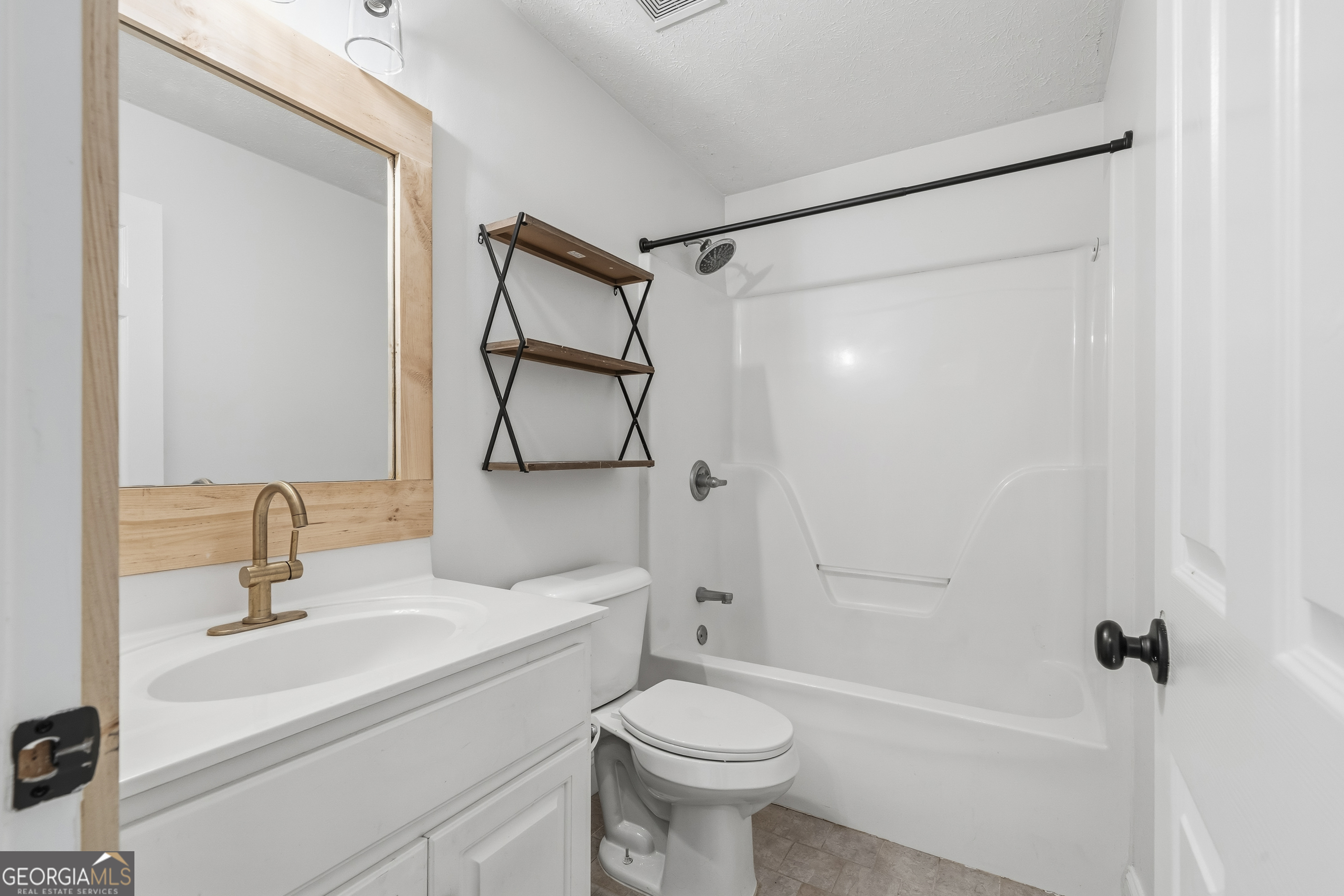 176 Arrowhead Trail Eatonton, GA 31024 - Photo 22 of 45 a bathroom with a sink toilet and shower
