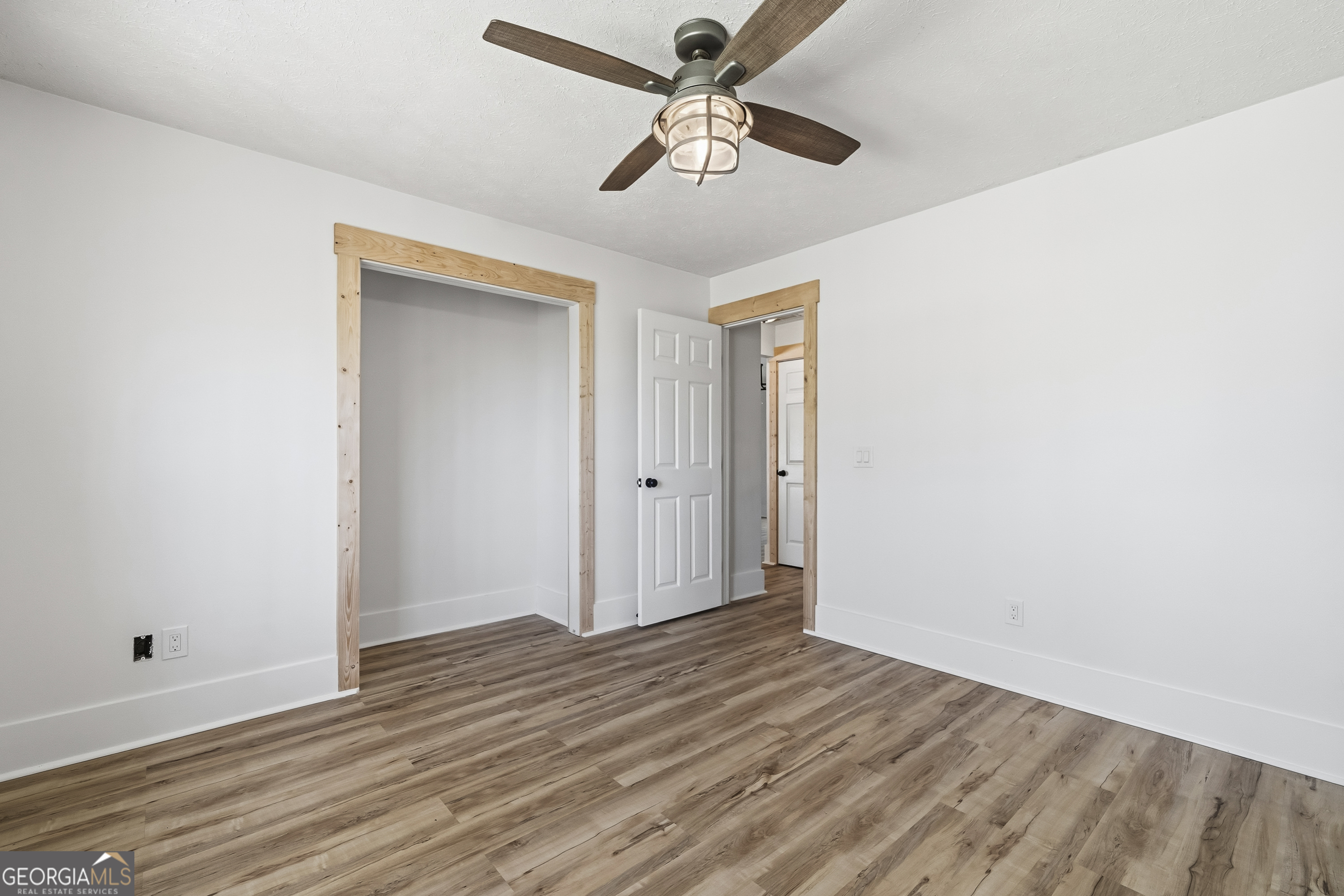 176 Arrowhead Trail Eatonton, GA 31024 - Photo 24 of 45 a view of room with hardwood floor and a ceiling fan