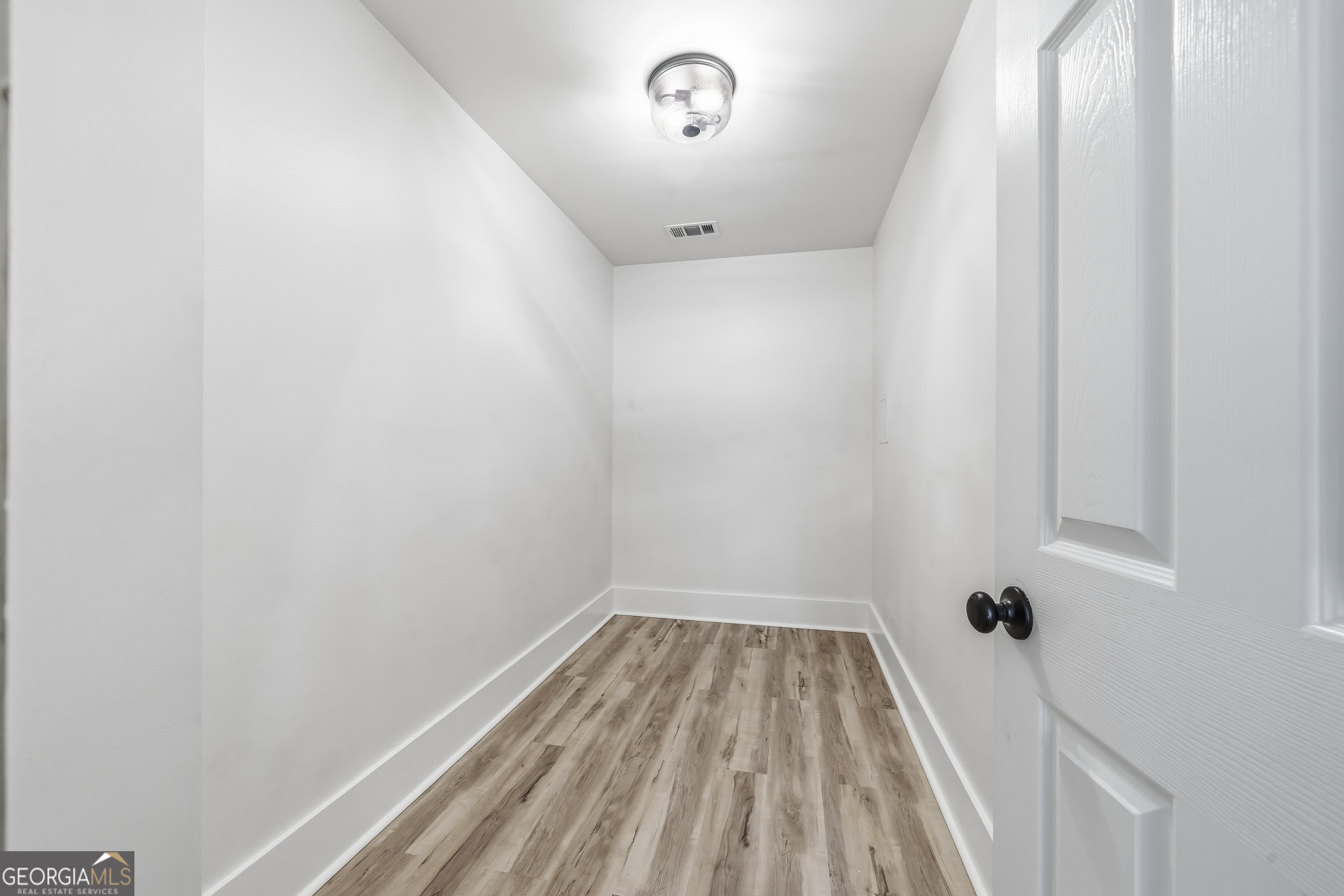 176 Arrowhead Trail Eatonton, GA 31024 - Photo 30 of 45 a view of a room with wooden floor and white walls