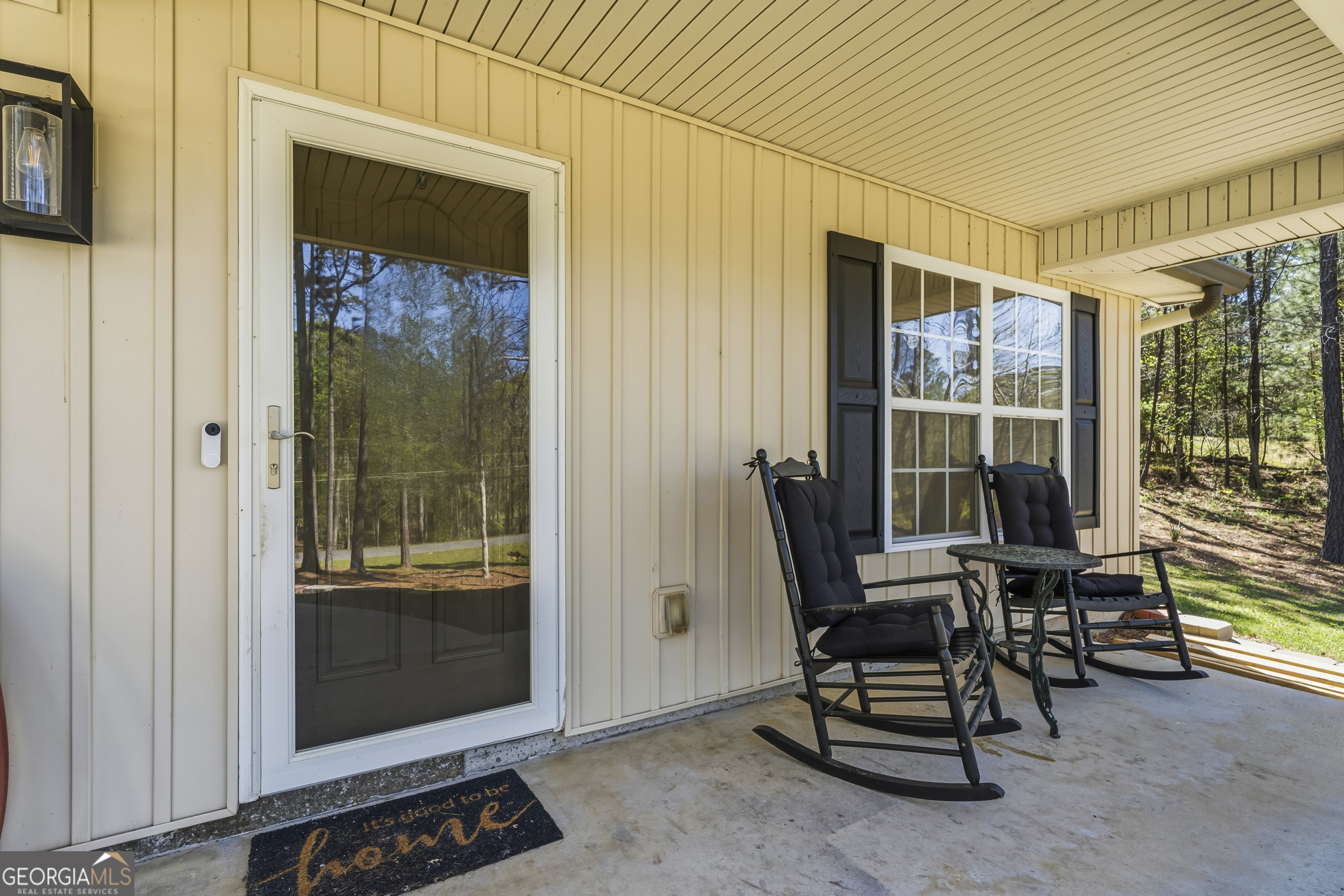 176 Arrowhead Trail Eatonton, GA 31024 - Photo 5 of 45 a view of a balcony with chair and glass door