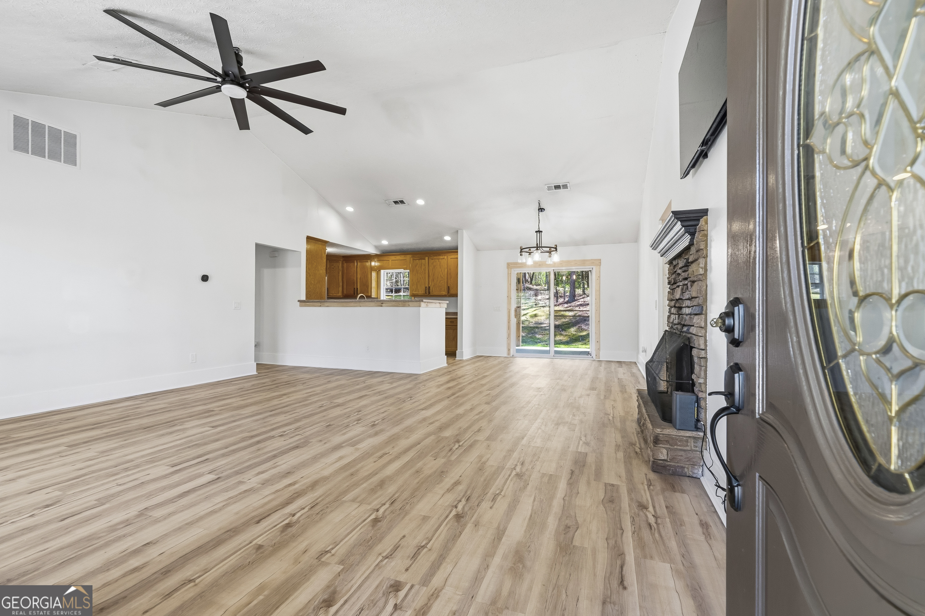 176 Arrowhead Trail Eatonton, GA 31024 - Photo 7 of 45 a view of empty room with wooden floor and fan