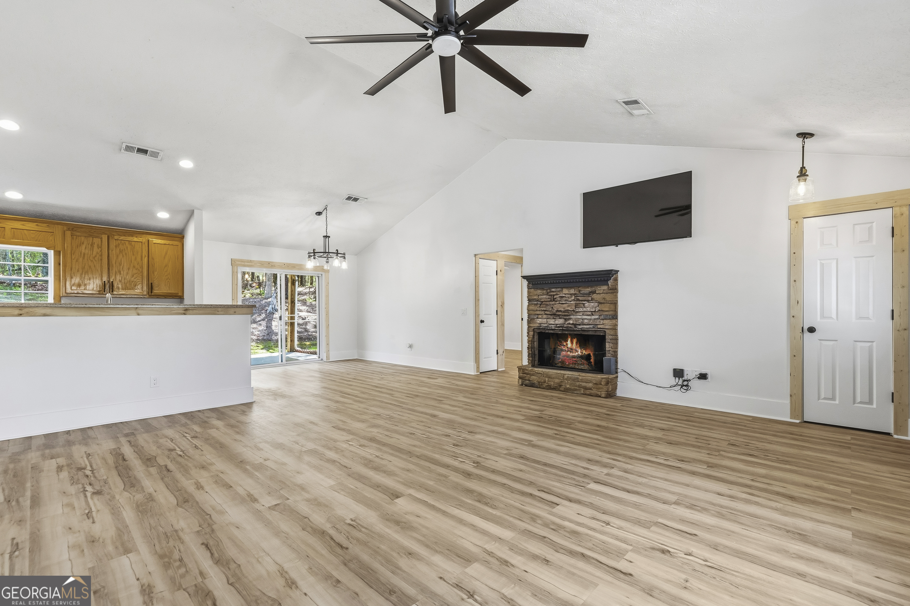 176 Arrowhead Trail Eatonton, GA 31024 - Photo 10 of 45 a view of a livingroom with a fireplace a ceiling fan and wooden floor