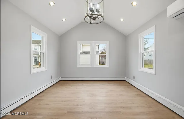 an empty room with windows and closet