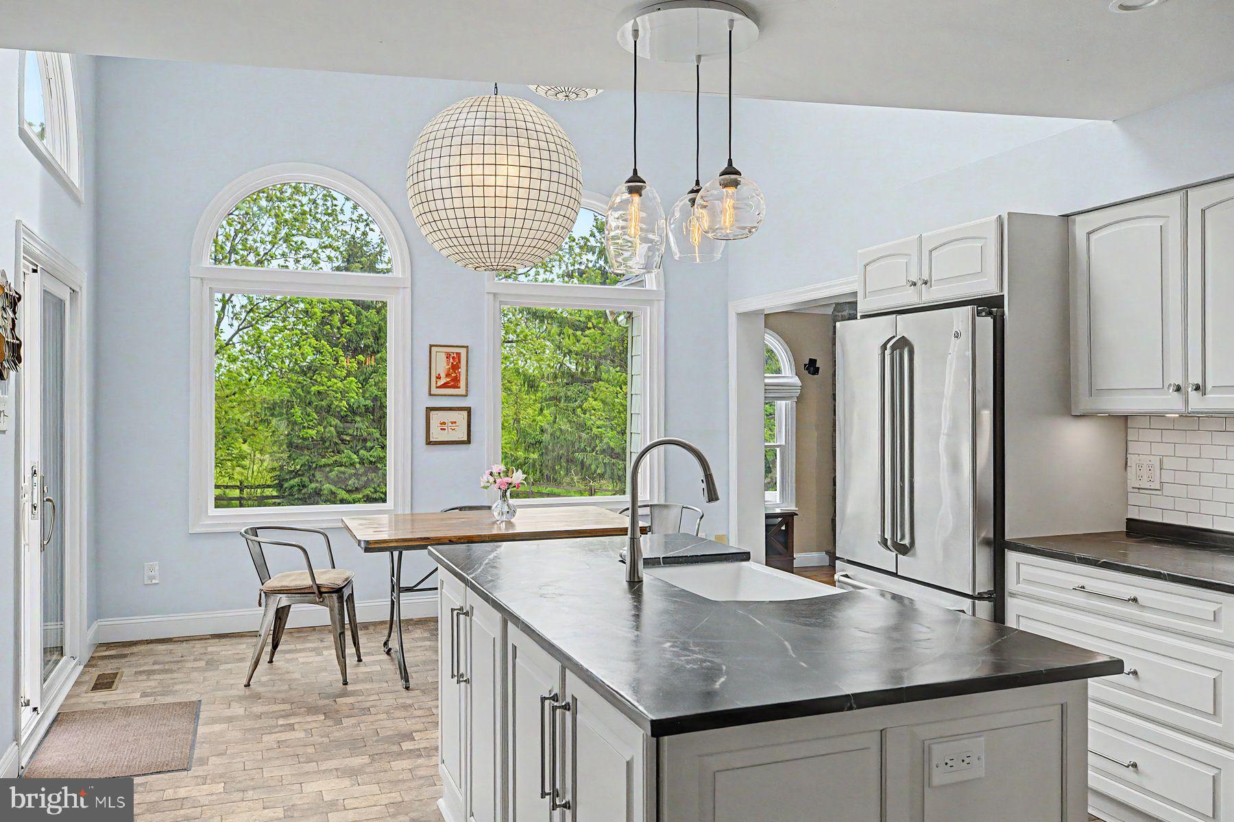 4009 Smoke Road Doylestown, PA 18902 - Photo 6 of 52 a kitchen with a table chairs and a chandelier