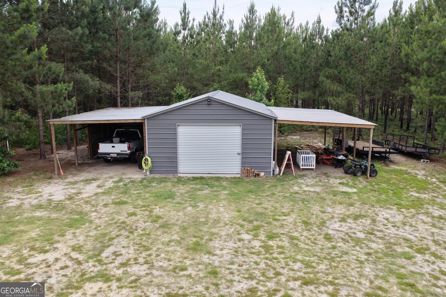 210 St Galilee Road Swainsboro, GA 30401 - Photo 18 of 18 a view of a house with a yard and sitting area