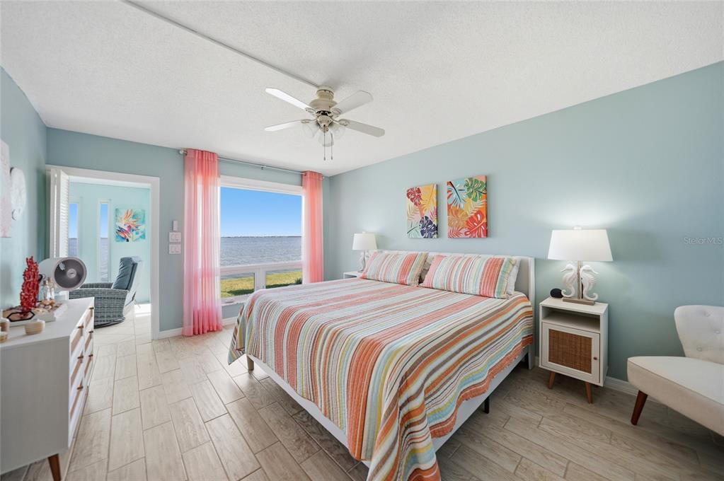 1 Colony Point Drive, Unit A10 Punta Gorda, FL 33950 - Photo 15 of 31 a bedroom with a bed wooden floor and window