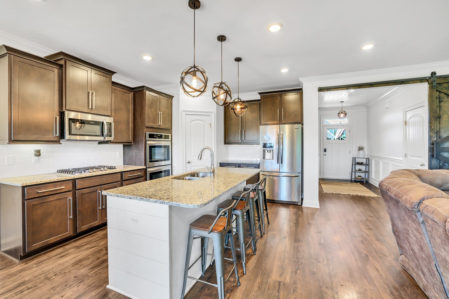 1142 Batbriar Road Murfreesboro, TN 37128 - Photo 13 of 60 a large kitchen with stainless steel appliances kitchen island granite countertop a stove a sink dishwasher and a refrigerator with wooden floor