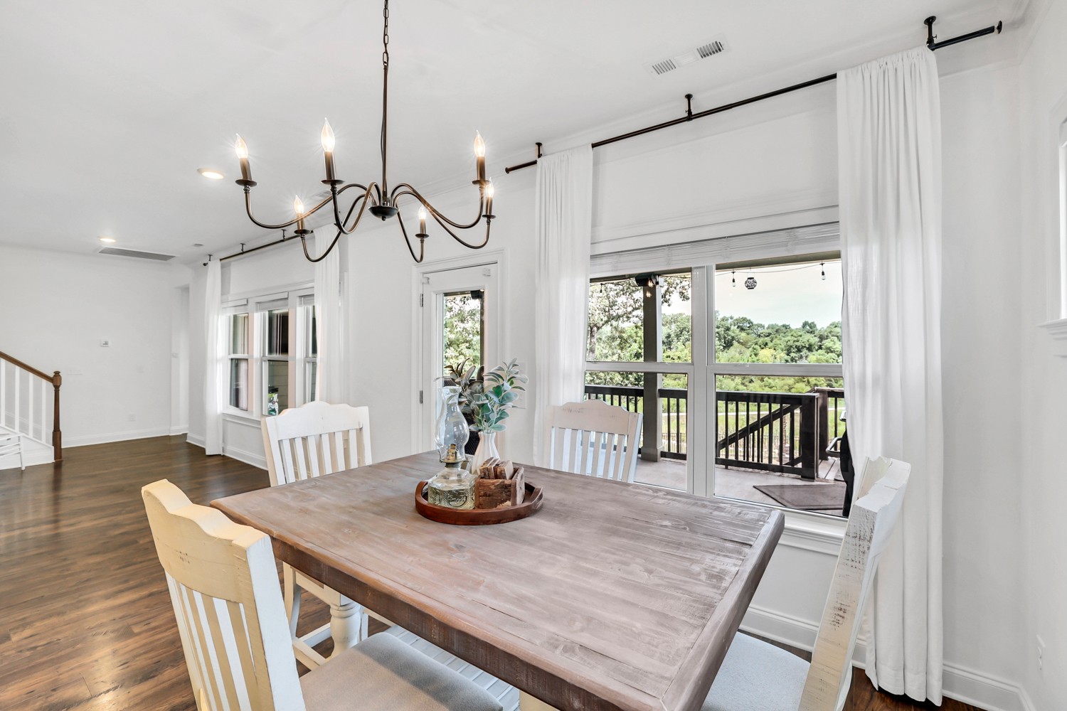 1142 Batbriar Road Murfreesboro, TN 37128 - Photo 19 of 60 a view of a dining room with furniture a chandelier and wooden floor