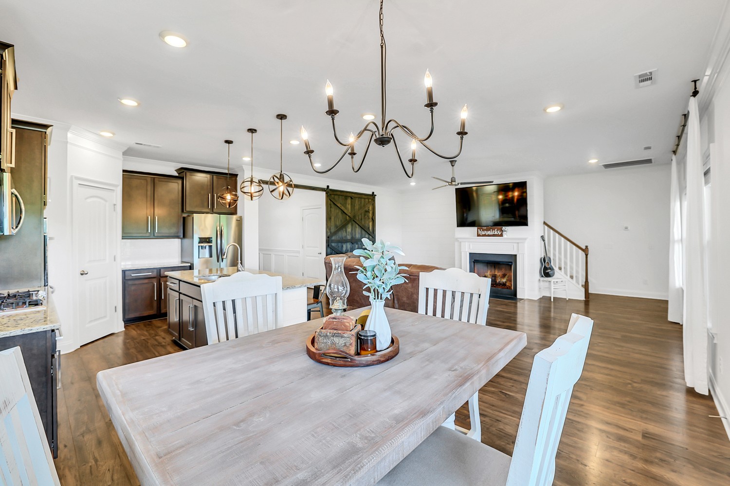 1142 Batbriar Road Murfreesboro, TN 37128 - Photo 22 of 60 a view of a dining room with furniture a chandelier and wooden floor