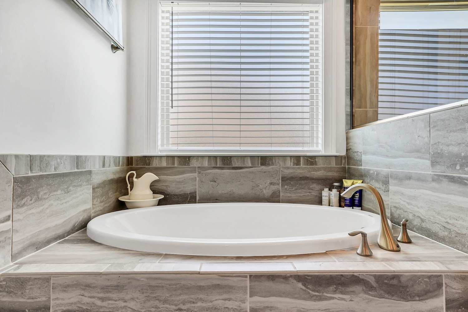 1142 Batbriar Road Murfreesboro, TN 37128 - Photo 31 of 60 a white bath tub sitting in a bathroom next to a window