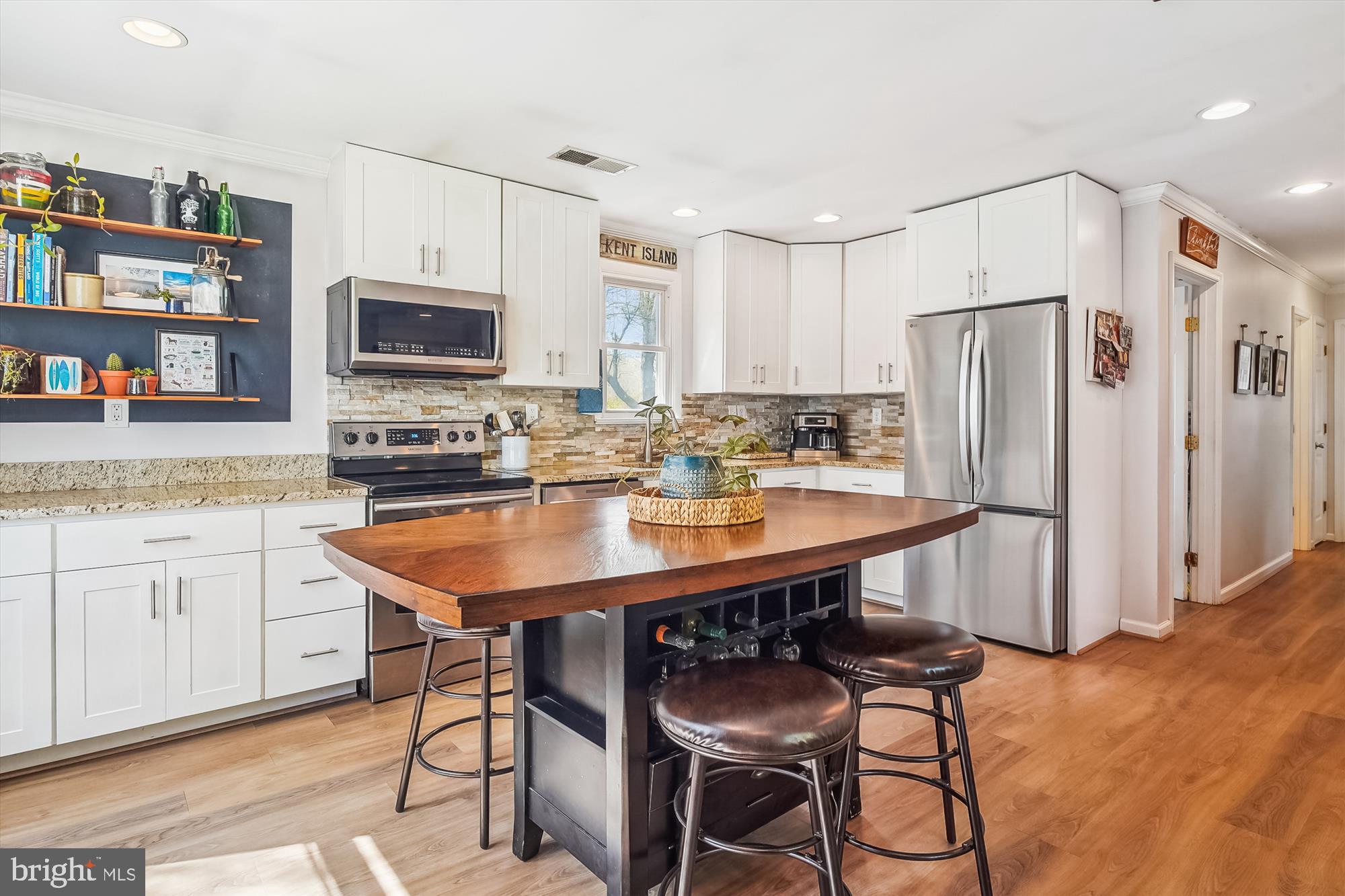 204 McKay Road Stevensville, MD 21666 - Photo 12 of 31 a kitchen with stainless steel appliances granite countertop a sink a stove a refrigerator cabinets and chairs
