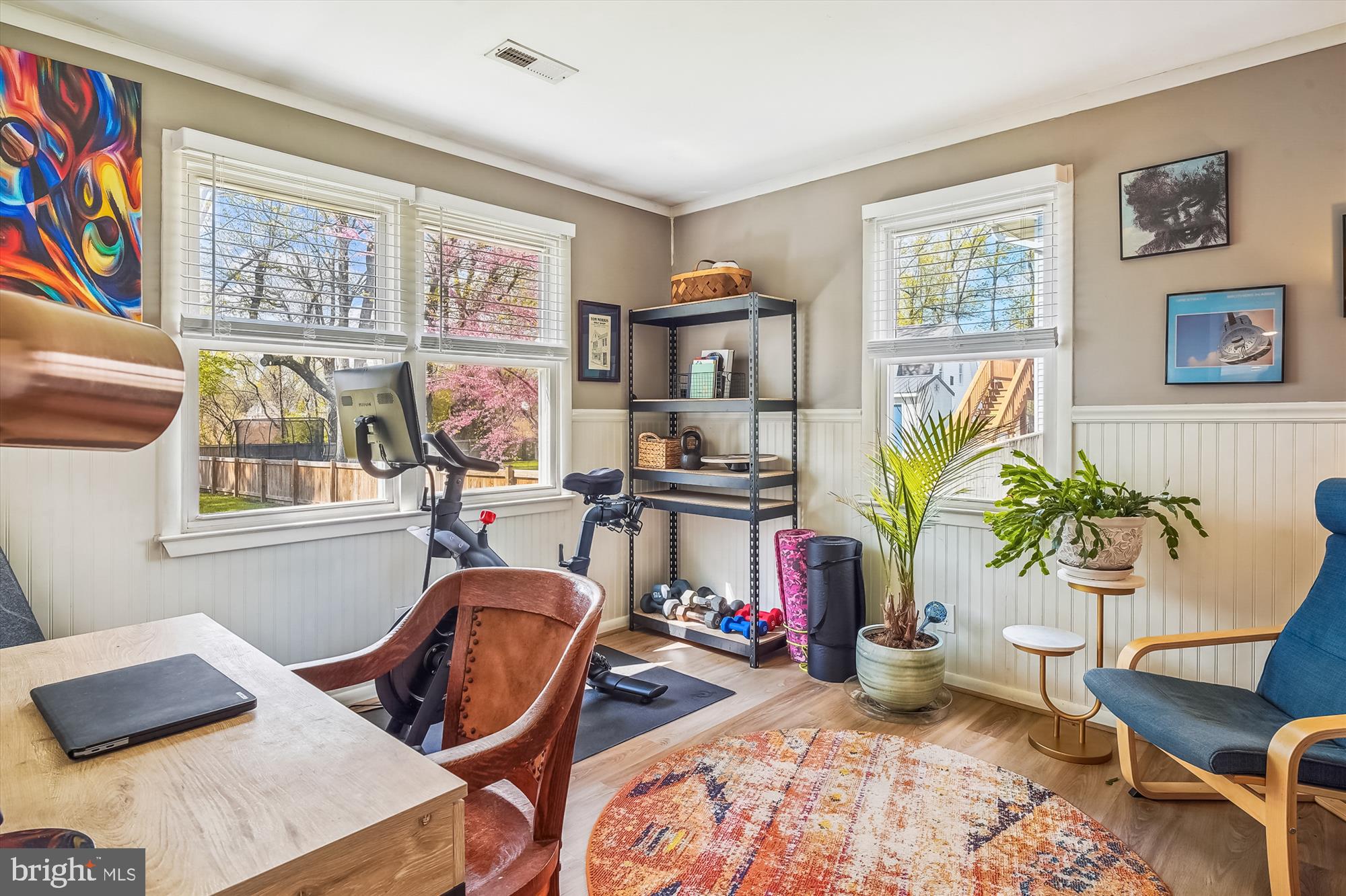 204 McKay Road Stevensville, MD 21666 - Photo 19 of 31 a living room with furniture and paintings on the wall next to a window