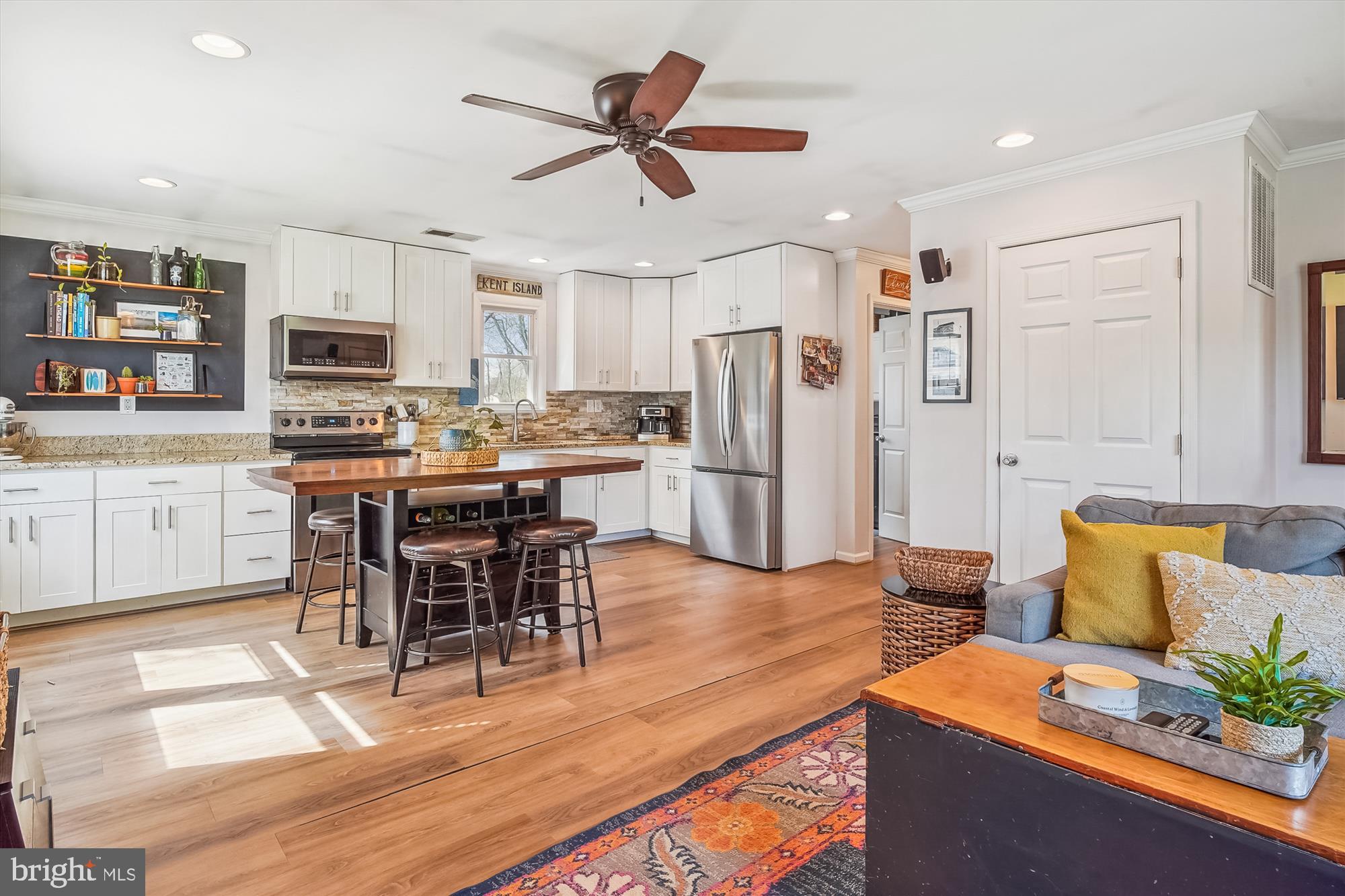 204 McKay Road Stevensville, MD 21666 - Photo 8 of 31 a living room with stainless steel appliances kitchen island granite countertop furniture and a wooden floor