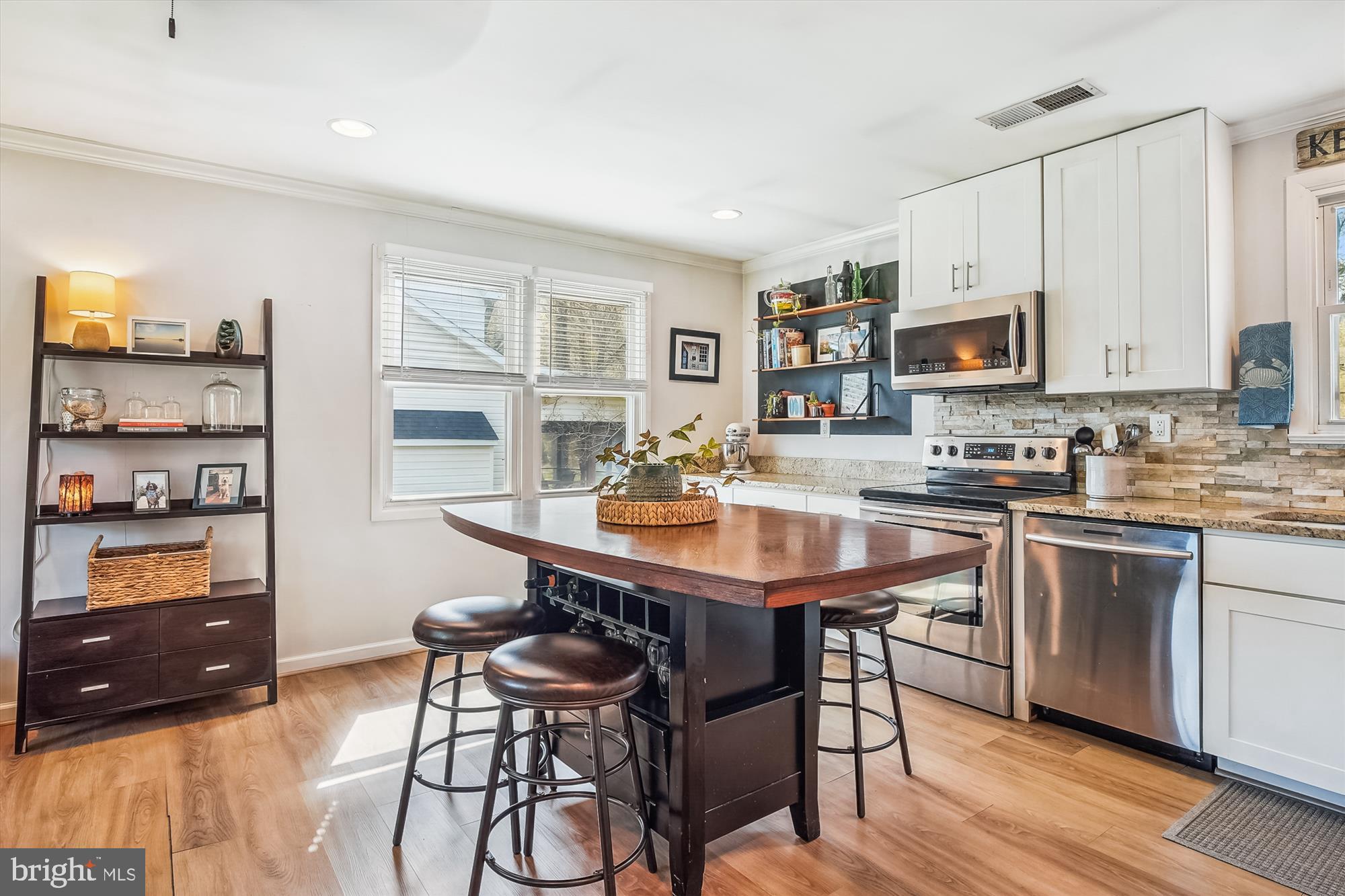 204 McKay Road Stevensville, MD 21666 - Photo 10 of 31 a kitchen with stainless steel appliances granite countertop a stove a sink dishwasher and cabinets with wooden floor