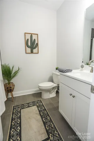 a bathroom with a sink toilet and a mirror