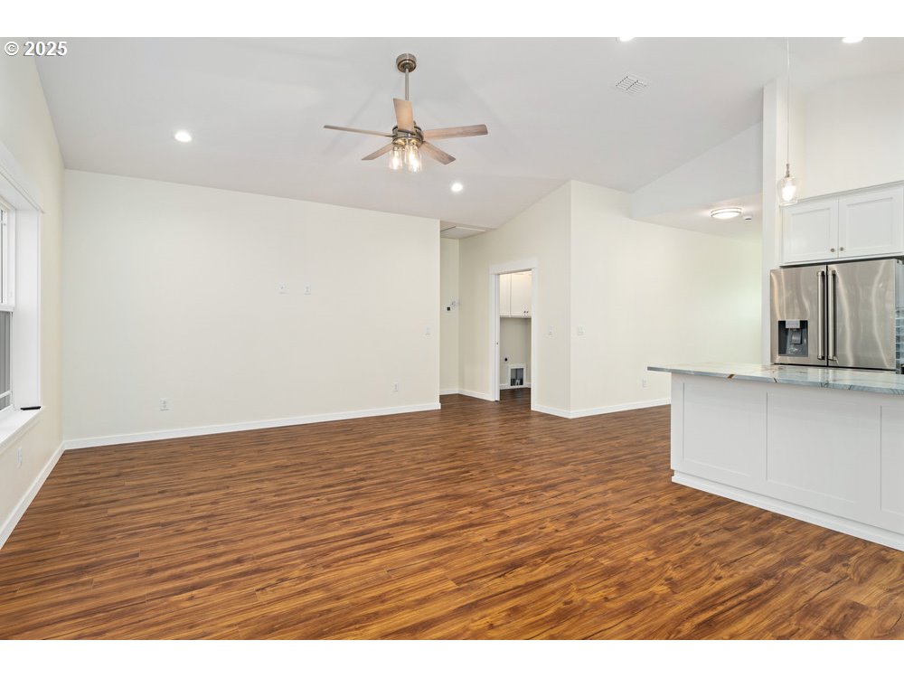 1241 Lighthouse Lane Brookings, OR 97415 - Photo 15 of 32 a view of kitchen and empty room with wooden floor